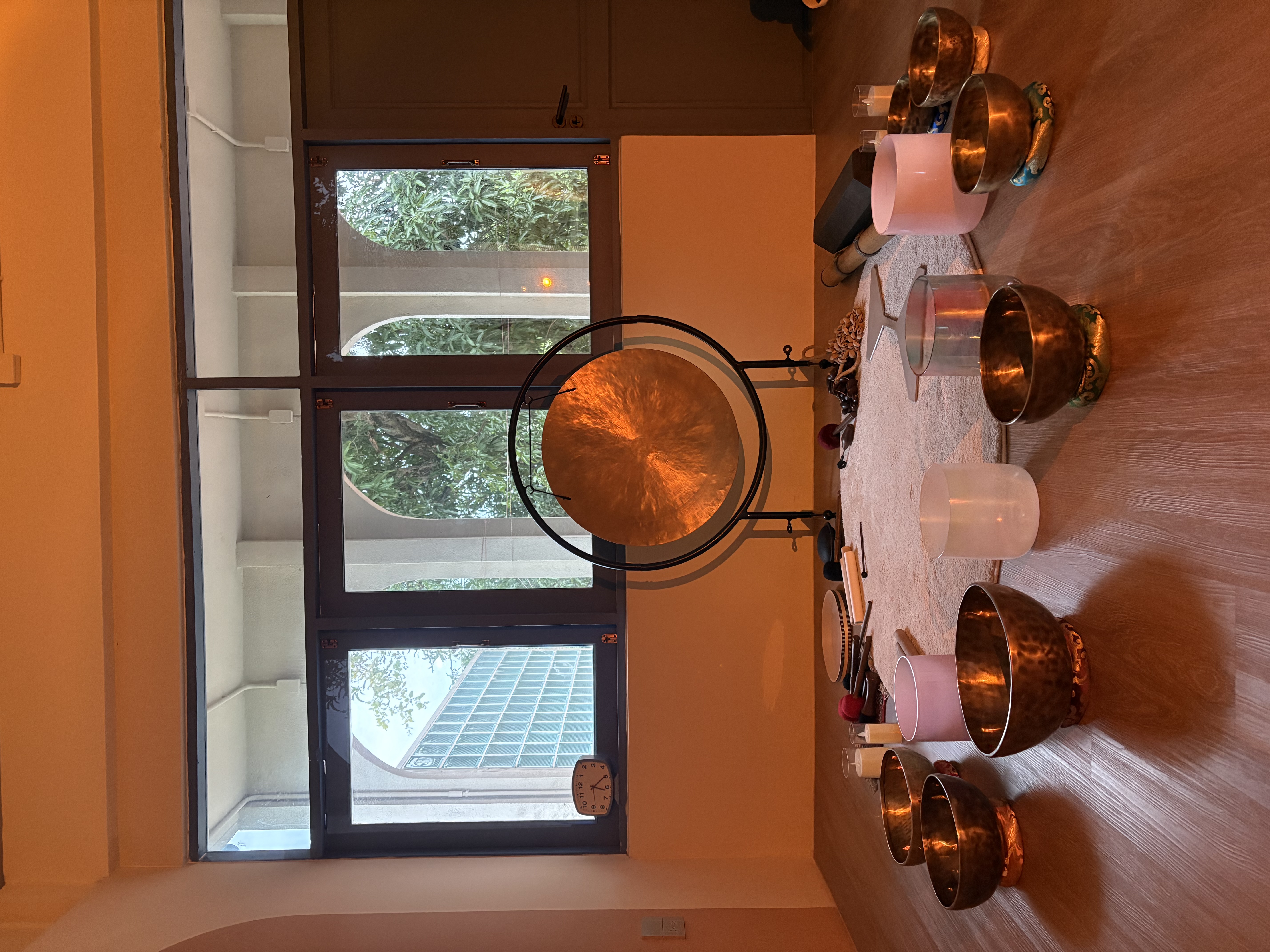 Gong and sound bowls in the warm-lit studio