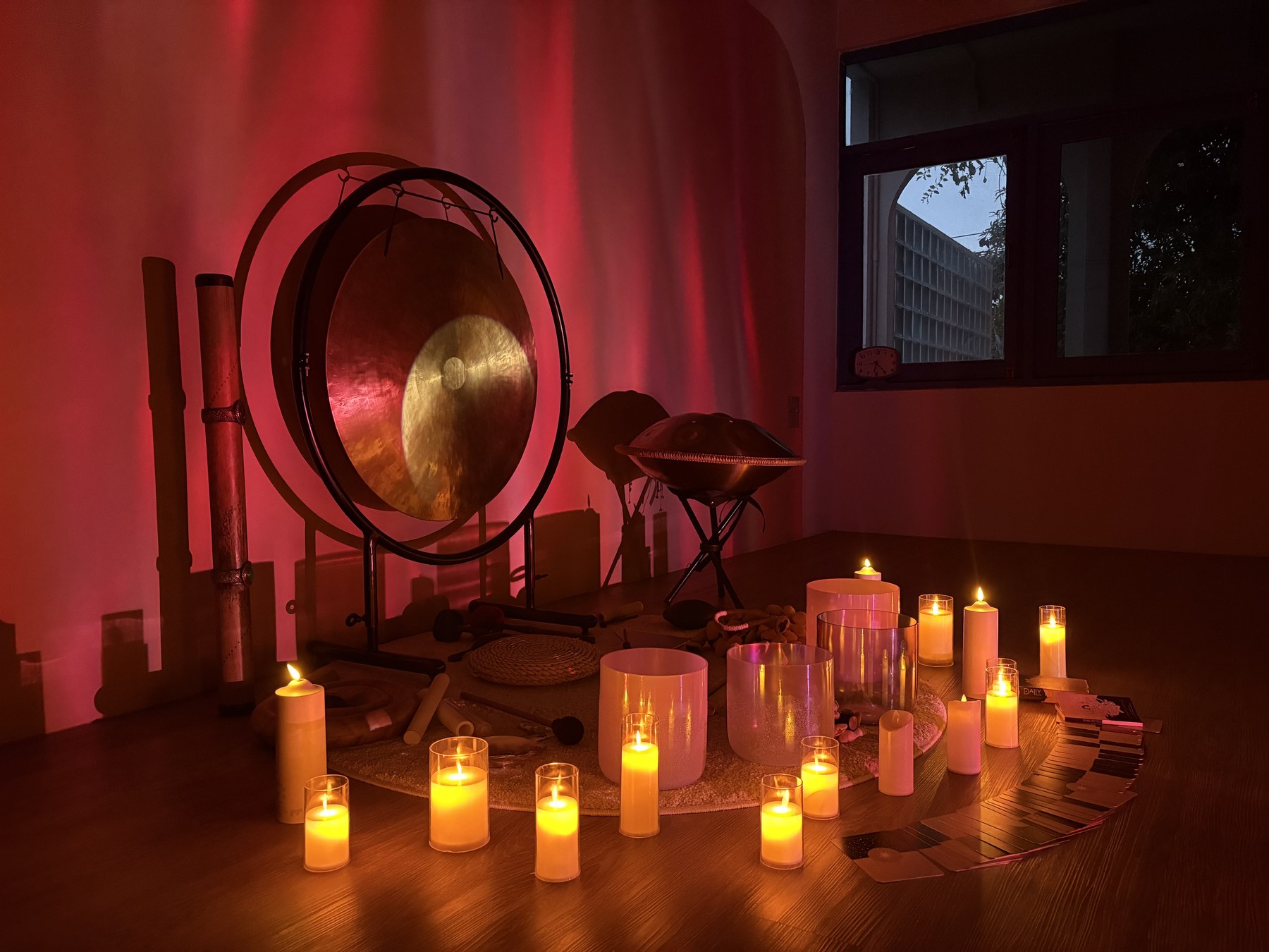 Gong and crystal bowls glowing in the studio's evening light